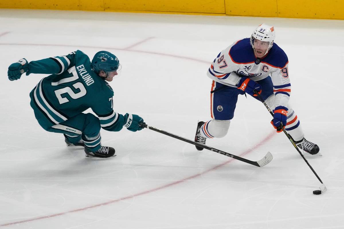 Edmonton Oilers center Connor McDavid (97) skates with the puck against San Jose Sharks left wing William Eklund (72) during the third period of an NHL hockey game in San Jose, Calif., Wednesday, April 16, 2025. 