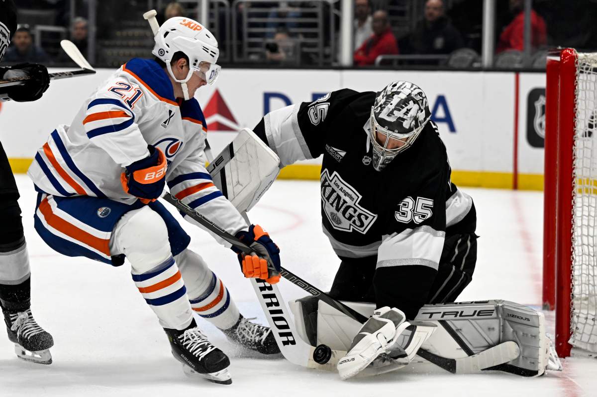 Los Angeles Kings goaltender Darcy Kuemper (35) stops a shot by Edmonton Oilers center Trent Frederic (21) during the first period of an NHL hockey game in Los Angeles, Saturday, April 5, 2025.