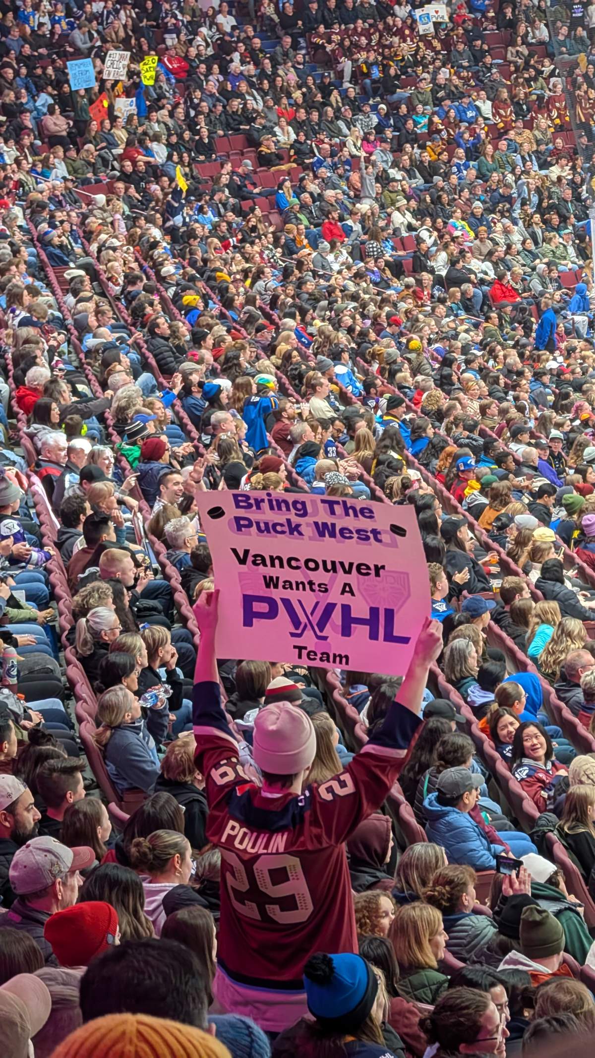 A fan holds up a sign at the sold-out PWHL Takeover Tour game at Rogers Arena in Vancouver on Jan. 8, 2025.