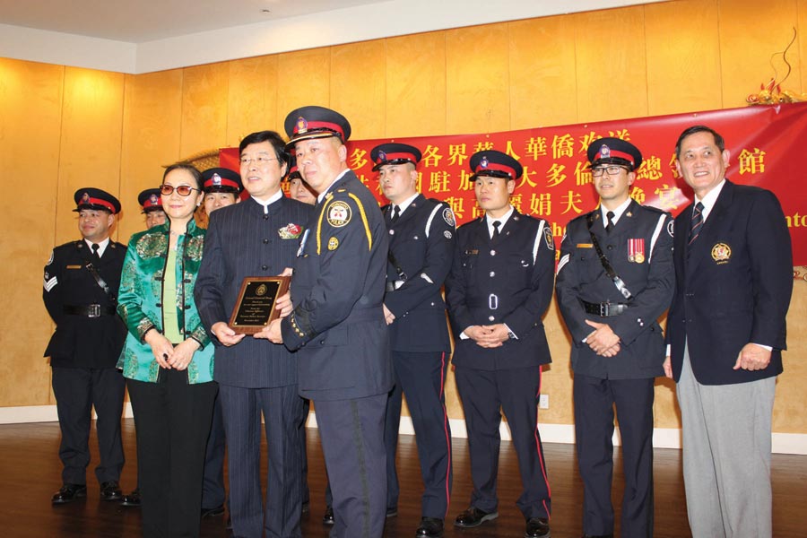 2016 photo shows Toronto Police officer Peter Yuen giving plaque to departing PRC Toronto consul, surrounded by 7 other Toronto police officers