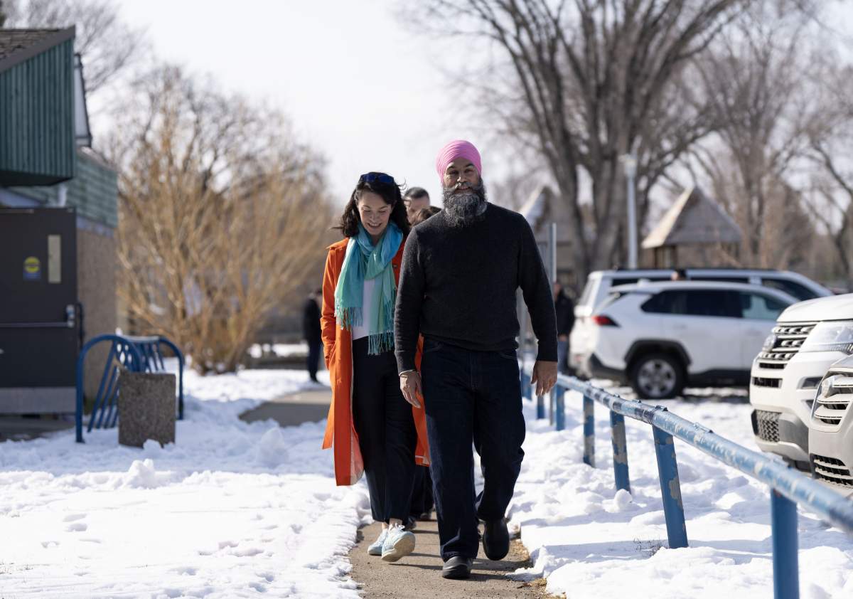 NDP Leader Jagmeet Singh walks with Edmonton Strathcona candidate Heather McPherson after making a health care announcement during a federal election campaign stop in Edmonton on Tuesday, April 1, 2025.