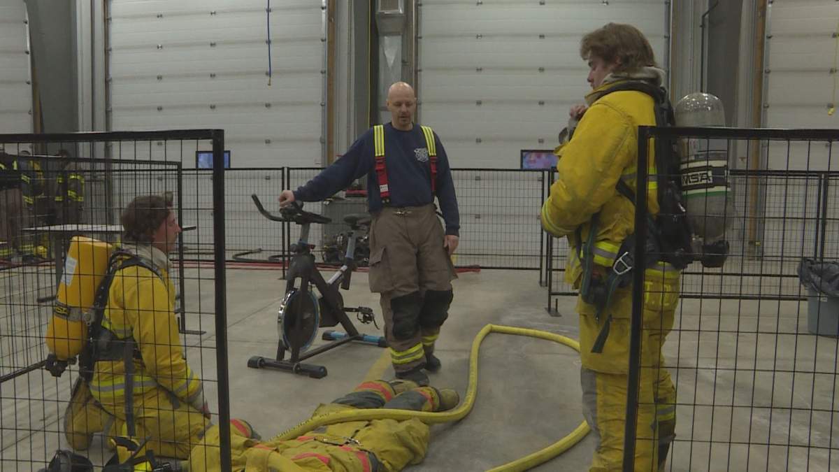 Dave Schellenberg (center) goes over recent training with firefighters.