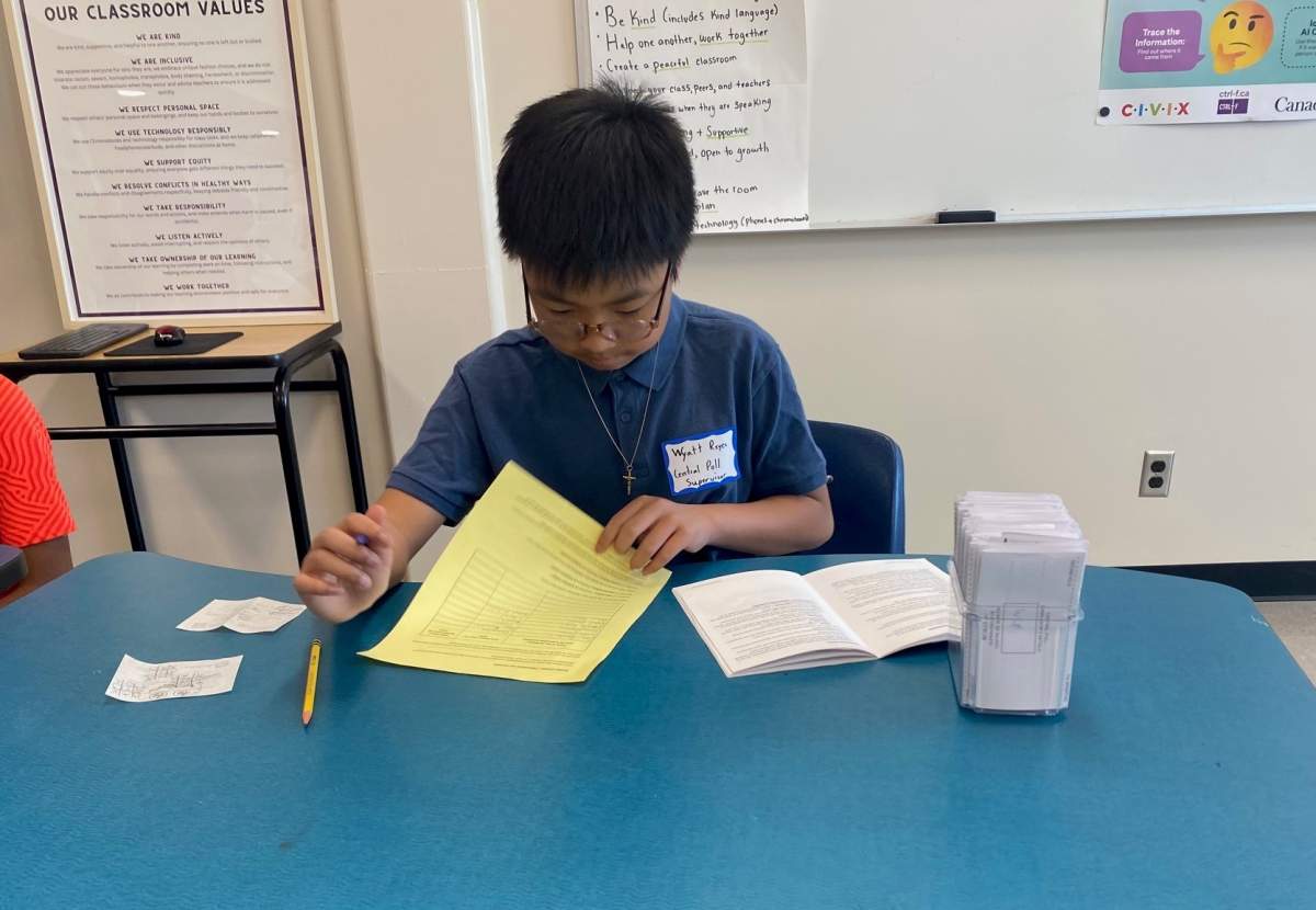 Twelve-year-old Wyatt Reyes acts as the central poll supervisor for Gordon Bell High School during the Student Vote.