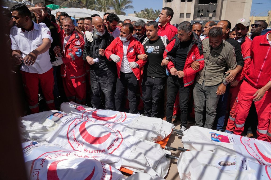 FILE.- Mourners gather around the bodies of 8 Red Crescent emergency responders, recovered in Rafah a week after an Israeli attack, as they are transported for burial from a hospital in Deir al-Balah, Gaza Strip, on Monday, March 31, 2025.