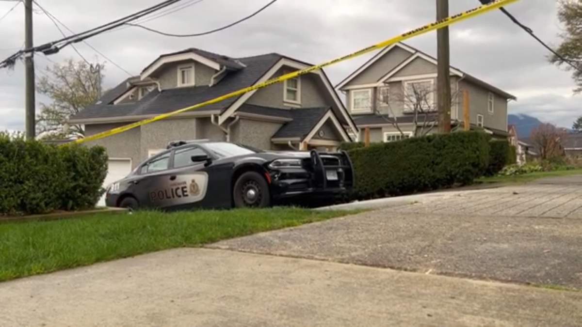 Crime scene tape surrounds a home in East Vancouver where police say officers responded to the fatal shooting of a man early Sunday morning.