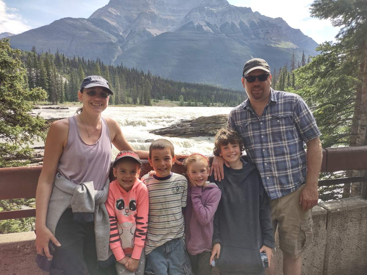 An undated Field family photo in the mountains. Emma is wearing the purple sweater, while Madison is in pink.