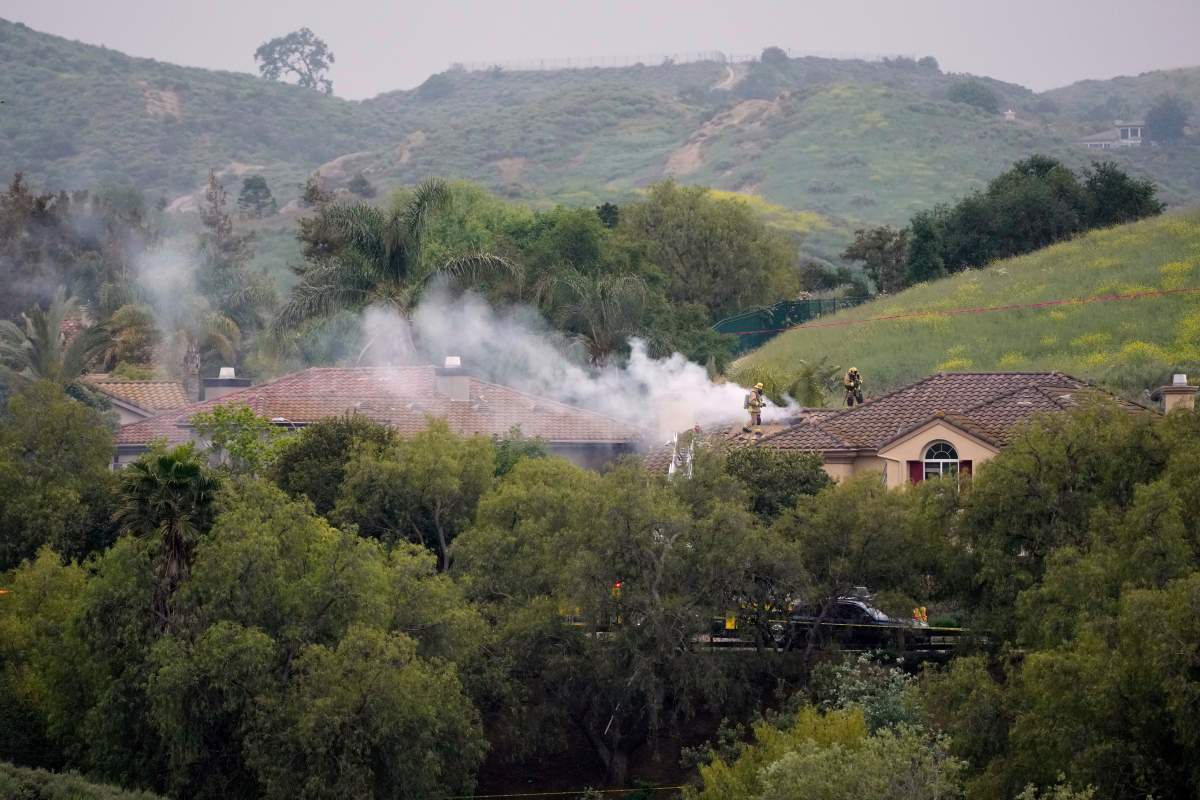 Firefighters work at the site of a plane crash in the Wood Ranch section of Simi Valley, Calif., on Saturday, May 3, 2025.