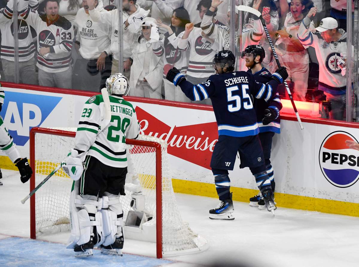 Winnipeg Jets' Mark Scheifele (55) celebrates his goal against Dallas Stars goaltender Jake Oettinger (29) with Kyle Connor (81) during second period NHL playoff hockey action in Winnipeg, Thursday, May 15, 2025. THE CANADIAN PRESS/Fred Greenslade.