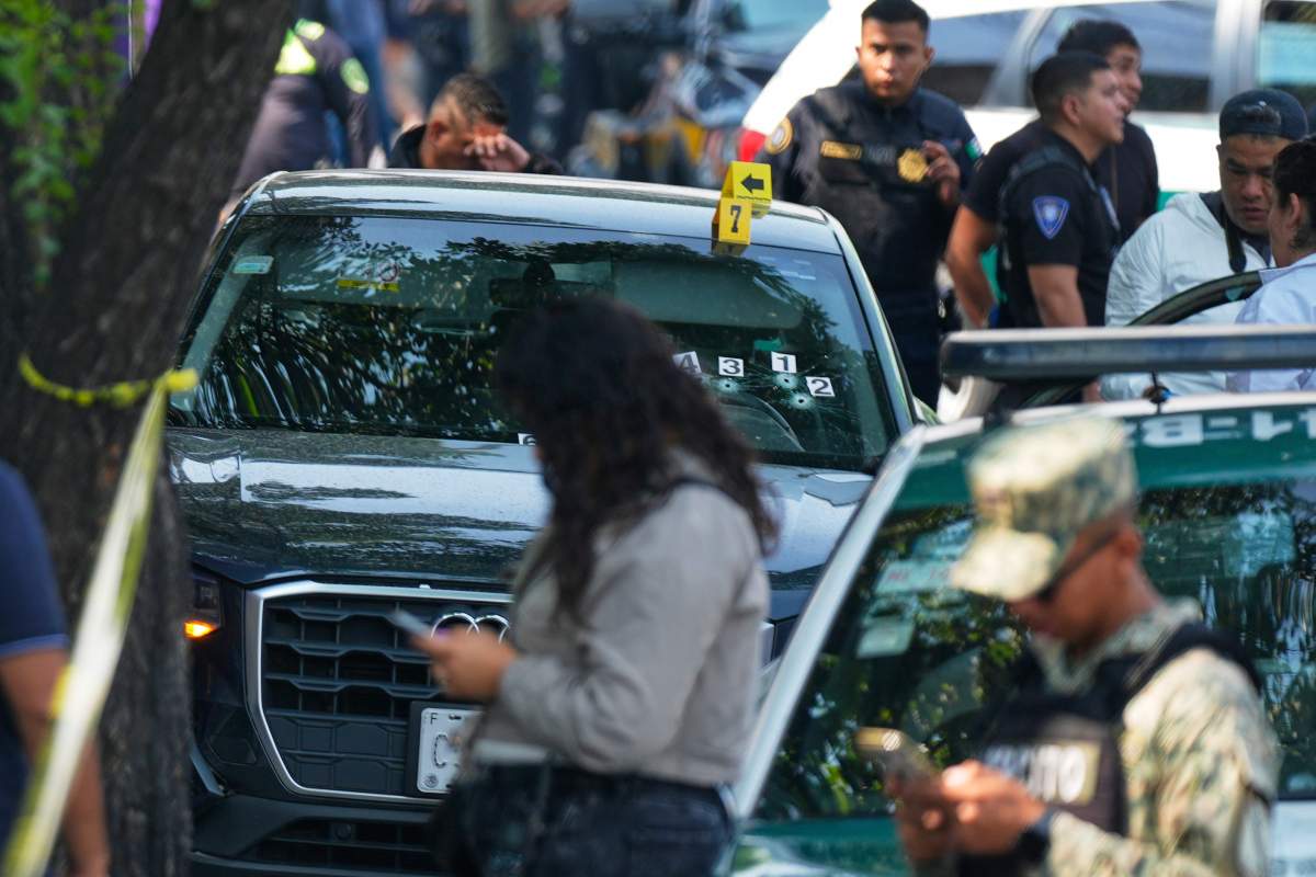 Police inspect the car where Mexico City Mayor Clara Brugada's private secretary, Ximena Guzman, and adviser, Jose Munoz, were killed in Mexico City, Tuesday, May 20, 2025.