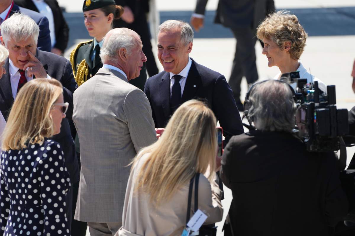 Prime Minister Mark Carney, centre right, welcomes King Charles as he arrives at the Ottawa International Airport in Ottawa for a royal visit with Queen Camilla on Monday, May 26, 2025. THE CANADIAN PRESS/Sean Kilpatrick