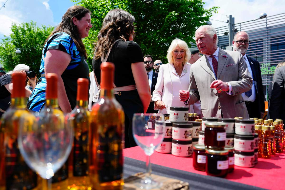 King Charles and Queen Camilla meet vendors from the Ottawa Farmer's Market at a community gathering at Lansdowne Park in Ottawa during a royal visit, on Monday, May 26, 2025. THE CANADIAN PRESS/Justin Tang