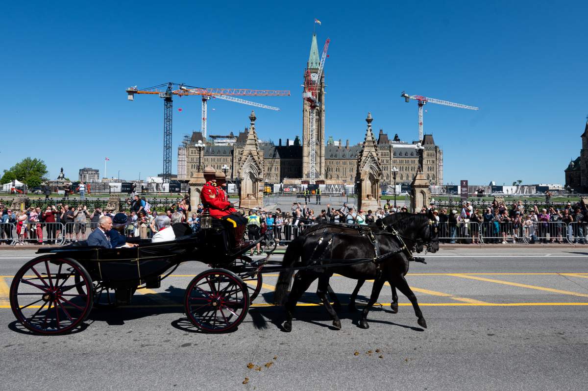 King Charles, Queen Camilla, Gov. Gen. Mary Simon and Whit Fraser husband to Governor General of Canada travel by Canada’s State Landau towards the Senate of Canada Building in Ottawa, on Tuesday, May 27, 2025. THE CANADIAN PRESS/Spencer Colby