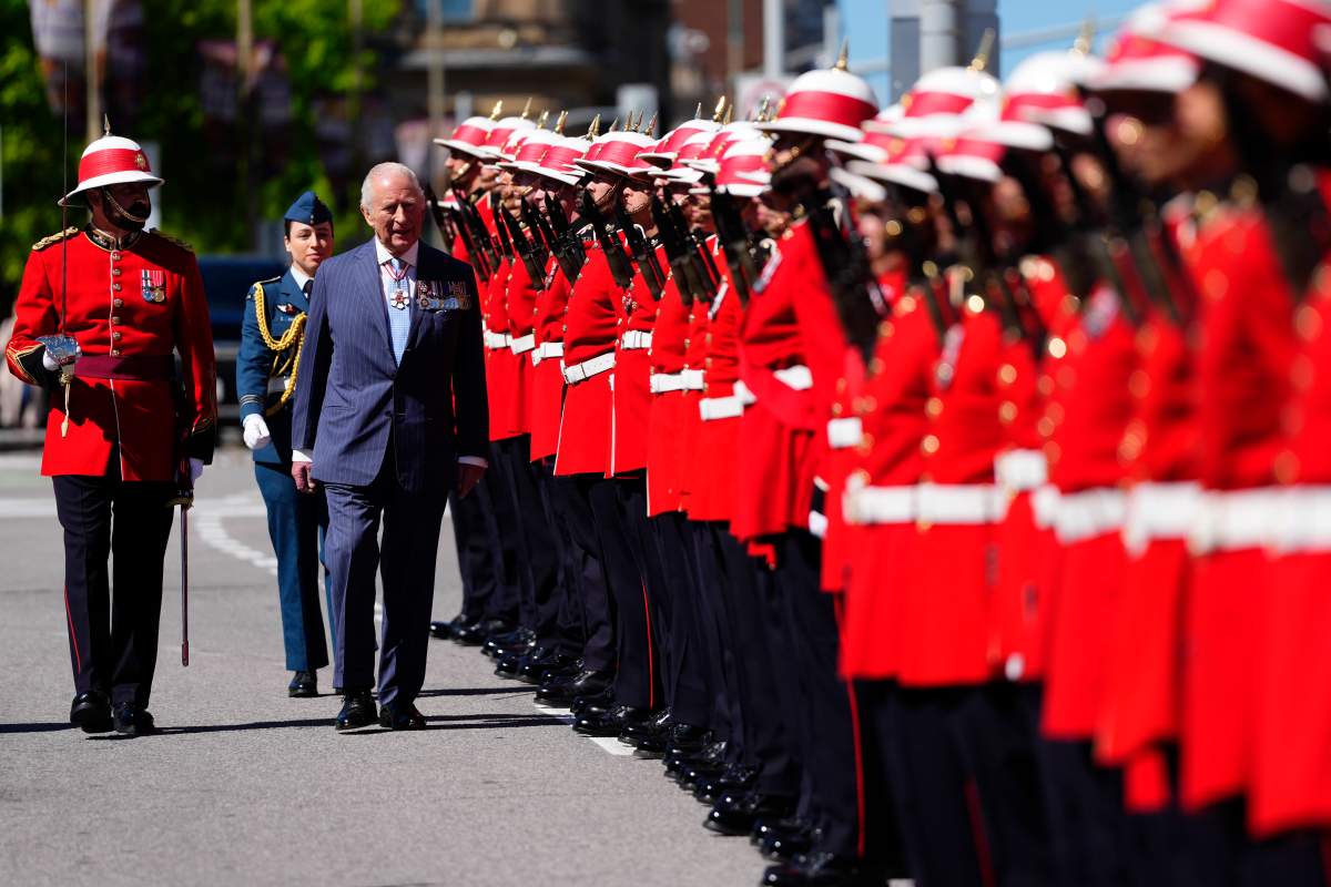 King Charles inspects an honour guard at the Senate of Canada building in Ottawa before reading the throne speech during a royal visit, on Tuesday, May 27, 2025. THE CANADIAN PRESS/Justin Tang