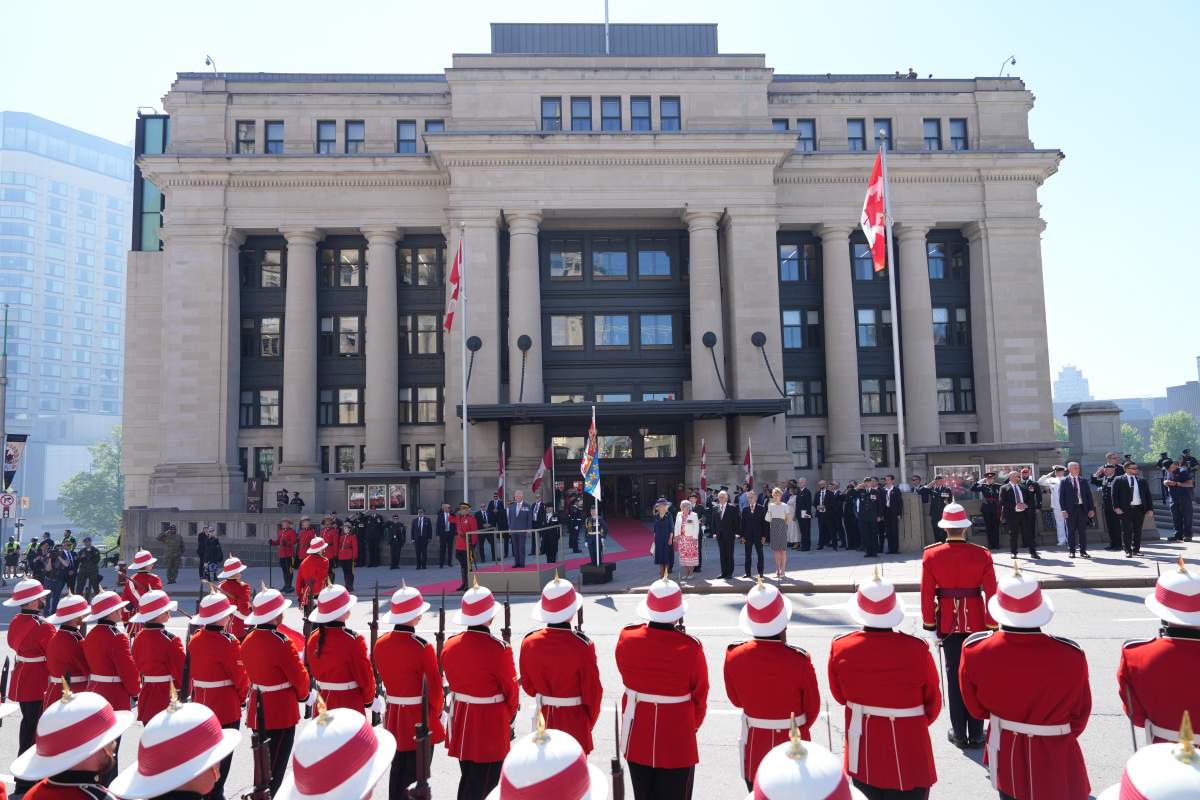 King Charles, centre left, finishes his inspection of the honour guard in front of the Senate in Ottawa on Tuesday, May 27, 2025. THE CANADIAN PRESS/Christinne Muschi