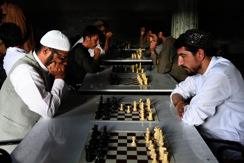 In this picture taken on June 30, 2022, people play chess games during a chess tournament in Kandahar.
