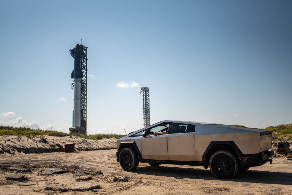 A Tesla Cybertruck faces the SpaceX Starship as it sits on a launch pad at Starbase near Boca Chica, Texas, on October 12, 2024.