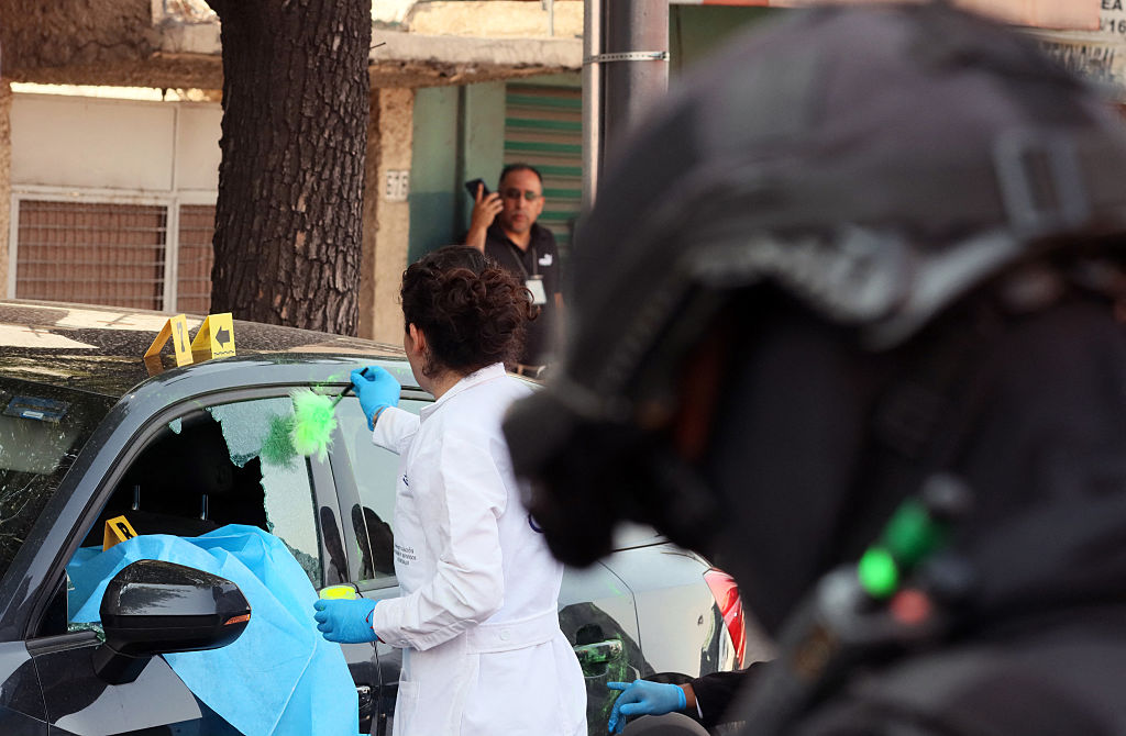 Forensic investigators work at the crime scene of the killing of Ximena Guzman in Mexico city on May 20, 2025. Gunmen on a motorcycle shot dead Guzman, an aide to Mexico City Mayor Clara Brugada, at a busy avenue in the capital on May 20, 2025, authorities said.