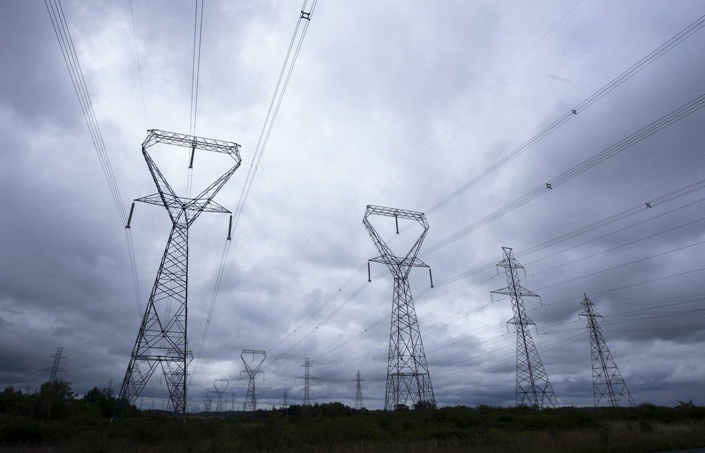 Power lines are seen against cloudy skies near Kingston, Ont., on Sept. 7, 2022. THE CANADIAN PRESS/Adrian Wyld.