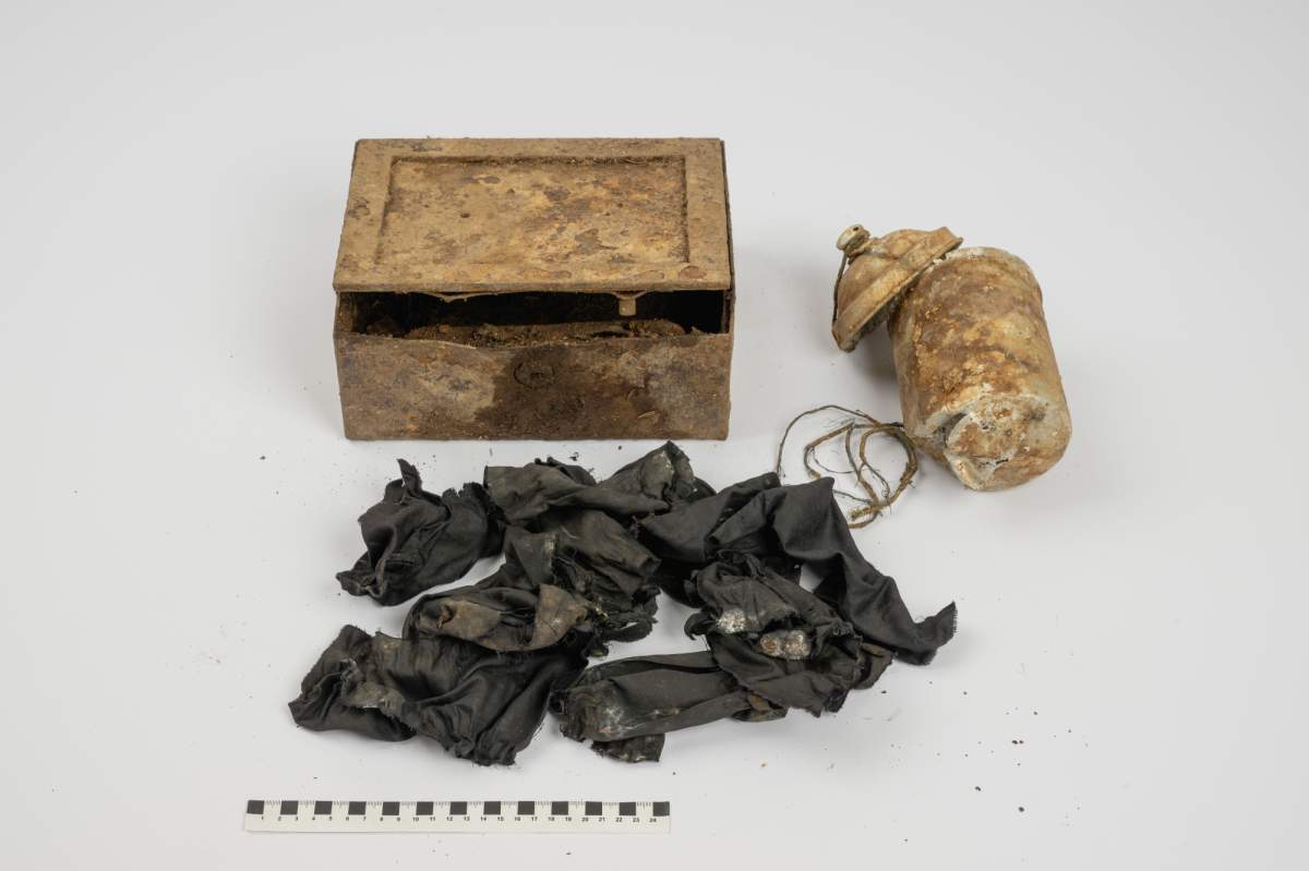 The two vessels and the black fabric used to wrap the coins.