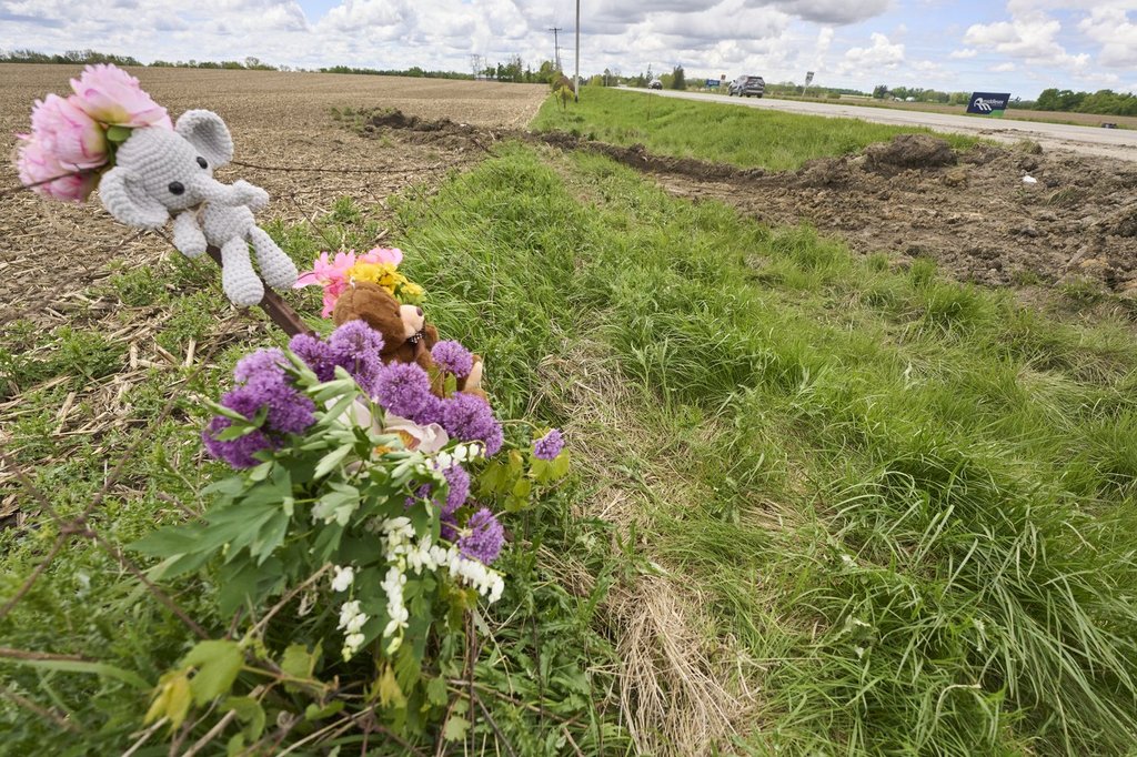 Flowers mark the site of a fatal accident which killed four students and a teacher northeast of London, Ont. on Sunday, May 25, 2025.THE CANADIAN PRESS/ Geoff Robins
