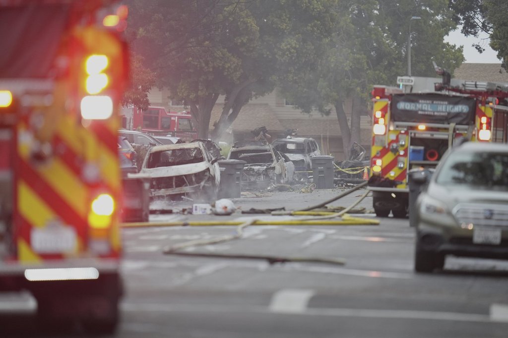 Authorities work the scene where a small plane crashed into a San Diego neighbourhood, setting several homes on fire and forcing evacuations along several blocks early Thursday, May 22, 2025.