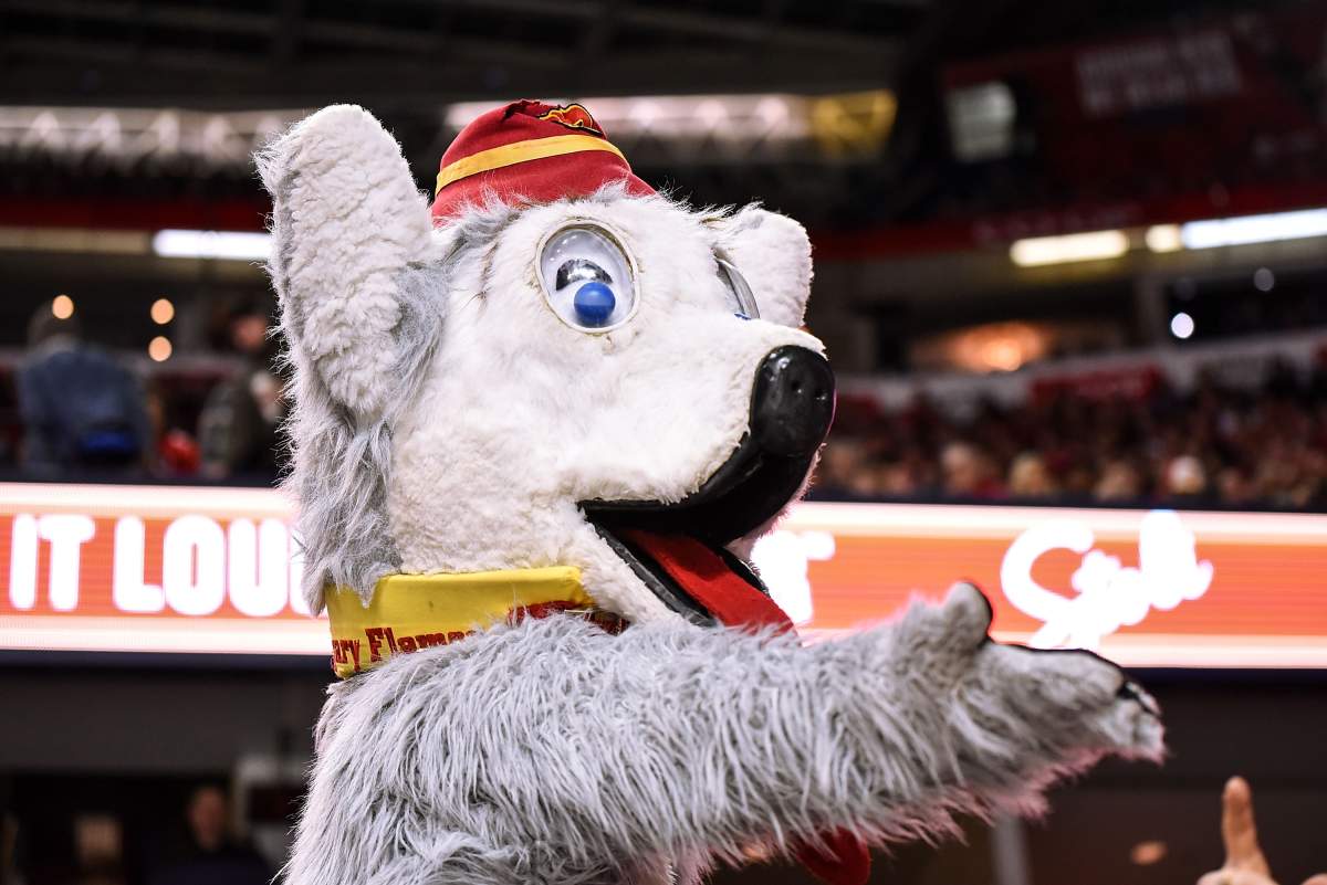 Calgary Flames mascot Harvey the Hound gestures to a fan during an NHL game in Calgary in November 2019.