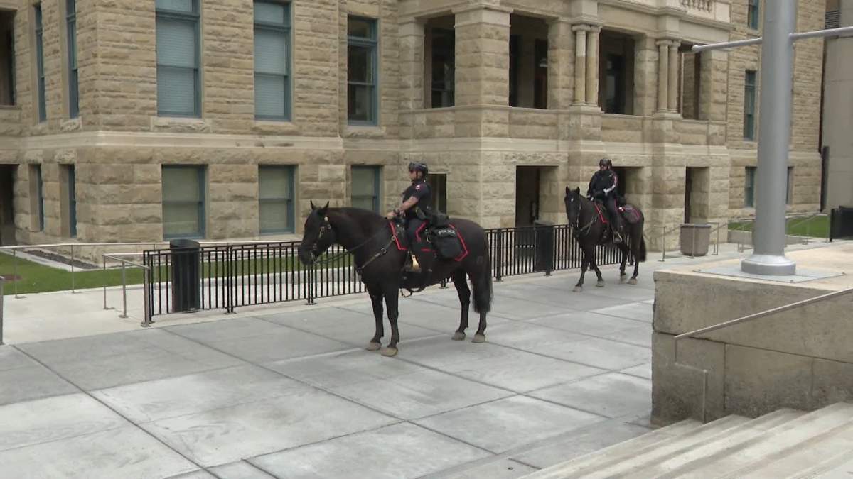 Police officers on horseback patrol Calgary municipal plaza, one of three designated demonstration zones during the upcoming G7 leaders summit in nearby Kananaskis.