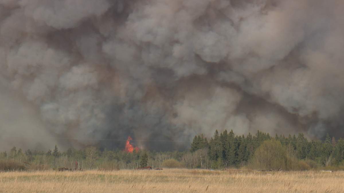 Dozens of homeowners who were forced from their homes because of a wildfire north of Edmonton, seen here on May 6, are now being allowed to return home after an evacuation order for the area was lifted on Tuesday morning.
