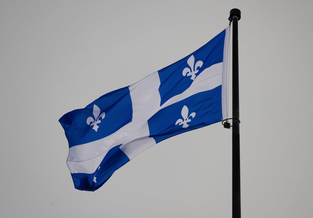 The Quebec Fleur-de-lis provincial flag flies on top of the national assembly’s main tower, Jan. 18, 2023, in Quebec City. THE CANADIAN PRESS/Jacques Boissinot.