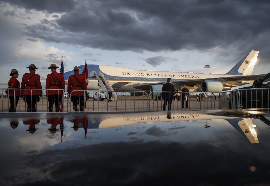 Mounties wait in front of Air Force 1 as U.S. President Donald Trump arrives in Calgary, Alta., on Sunday, June 15, 2025, to attend the G7 leaders meeting taking place in Kananaskis. THE CANADIAN PRESS/Jeff McIntosh