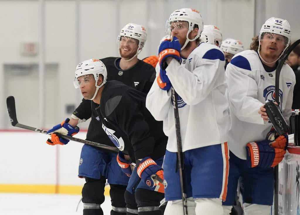 Edmonton Oilers defenceman Darnell Nurse, left, looks up ice during practice at the NHL Stanley Cup final in Fort Lauderdale, Fla., on Tuesday, June 10, 2025.