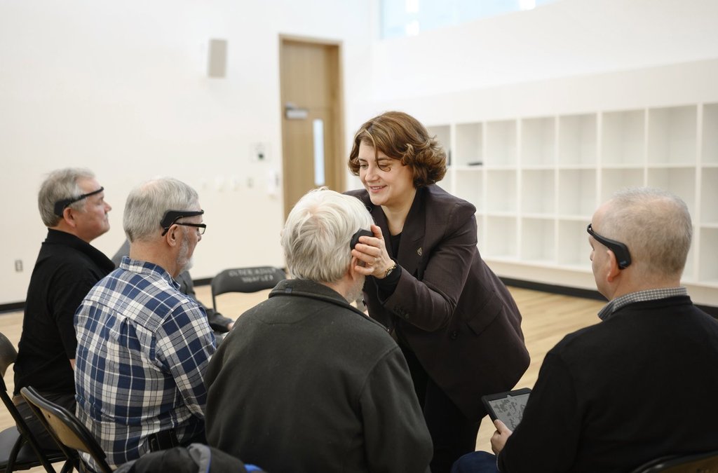 Dr. Gabriela Ilie, soillse scientist in prostate cancer quality of life research at Dalhousie University, second from right, adjusts a Muse device to measure brainwaves while leading a meditation session with prostate cancer patients in Halifax on Friday, Feb. 22, 2019. THE CANADIAN PRESS/Darren Calabrese