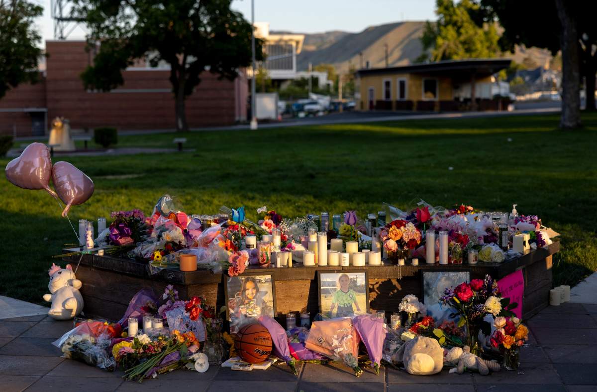 Pictures, flowers and candles mark a makeshift memorial Tuesday, June 3, 2025, in Wenatchee, Wash., in honor of Olivia, Paityn and Evelyn Decker, who were found dead near Leavenworth after their father Travis Decker failed to return them after a scheduled visitation.