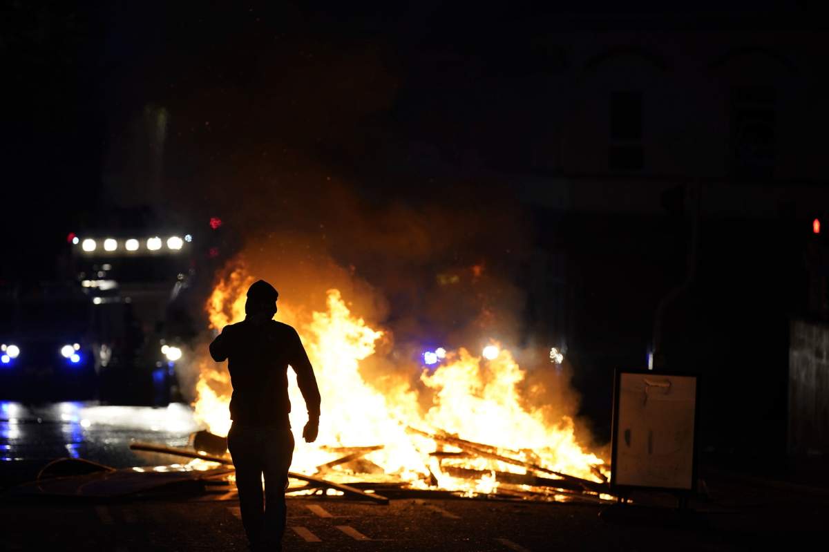 People take part in a protest over an alleged sexual assault in the Co Antrim town of Ballymena, Northern Ireland, Tuesday, June 10, 2025. (Niall Carson/PA via AP)