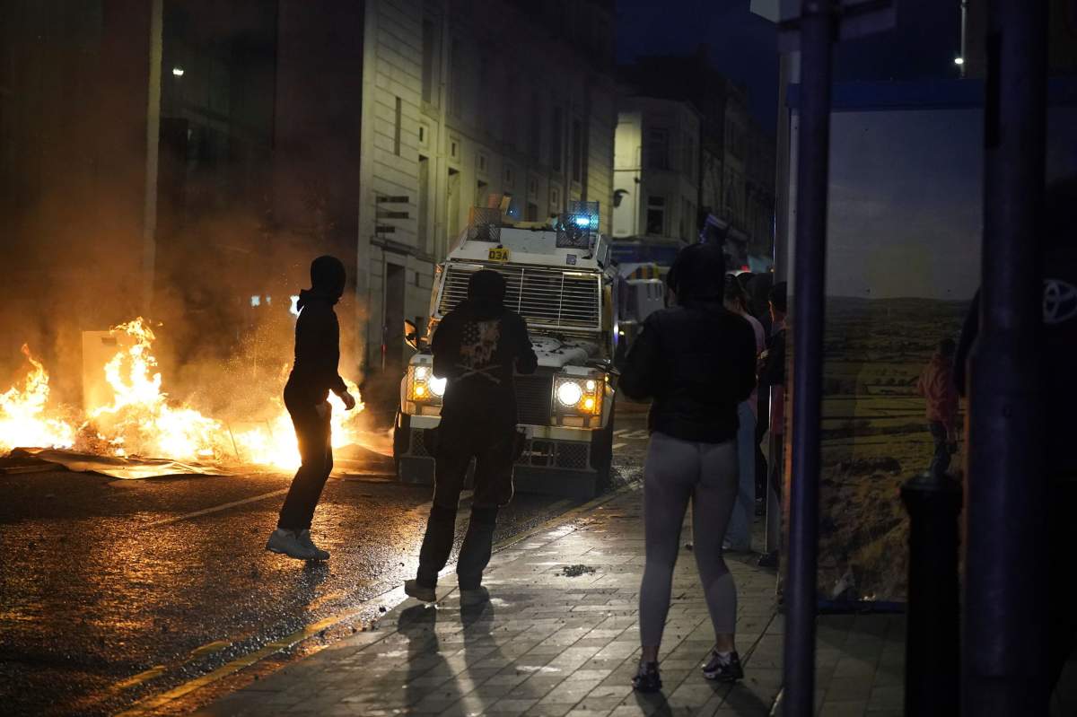 People take part in a protest over an alleged sexual assault in the Co Antrim town of Ballymena, Northern Ireland,, Tuesday June 10, 2025. (Niall Carson/PA via AP)