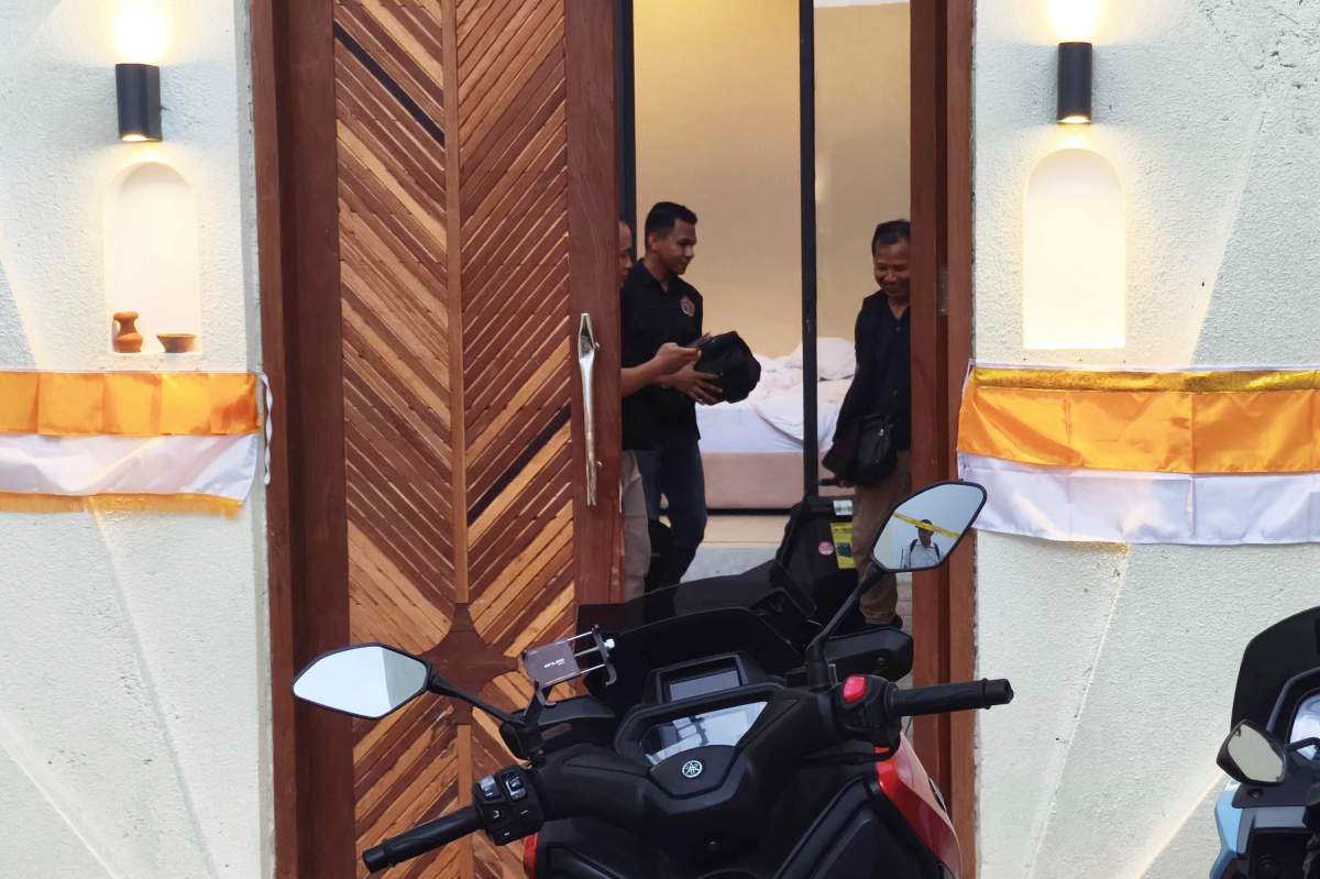 Plain-clothed police officers are seen inside a villa where a shooting that led to the death of an Australian man reportedly occurred, in Badung on the resort island of Bali, Indonesia, Saturday, June 14, 2025.