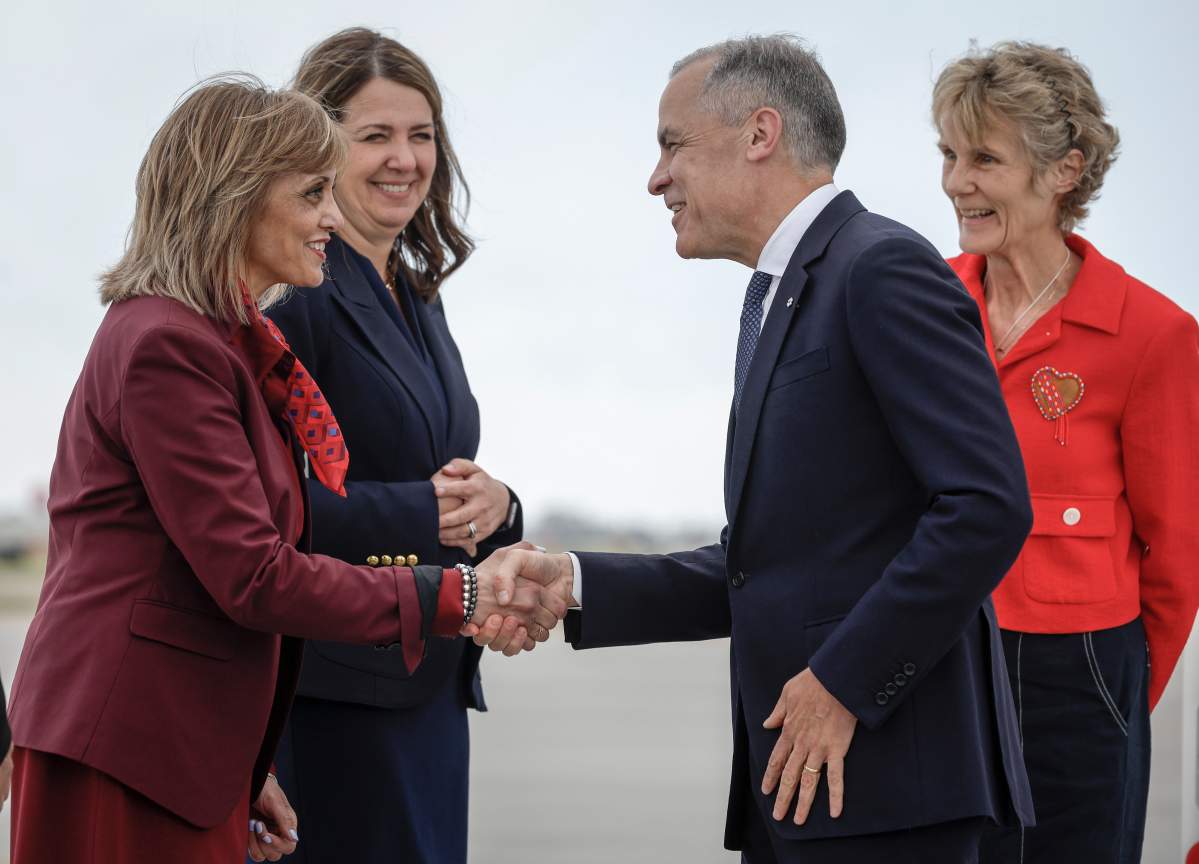 Canadian Prime Minister Mark Carney, centre right, and his wife Diana Fox Carney, right, are greeted by Calgary mayor Jyoti Gondek, left, and Alberta Premier Danielle Smith as they arrive in Calgary, Alta., Sunday, June 15, 2025, to attend the G7 Leaders meeting taking place in the nearby community of Kananaskis. THE CANADIAN PRESS/Jeff McIntosh
