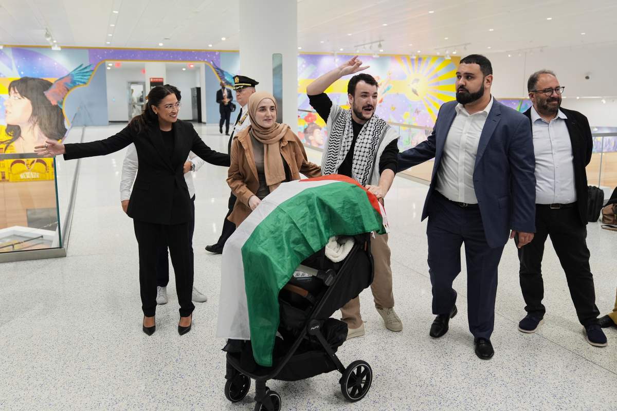 Mahmoud Khalil, center, reacts to supporters alongside his wife, Noor Abdallah, second from left, upon arriving at Newark International Airport, Saturday, June 21, 2025, in Newark, N.J.