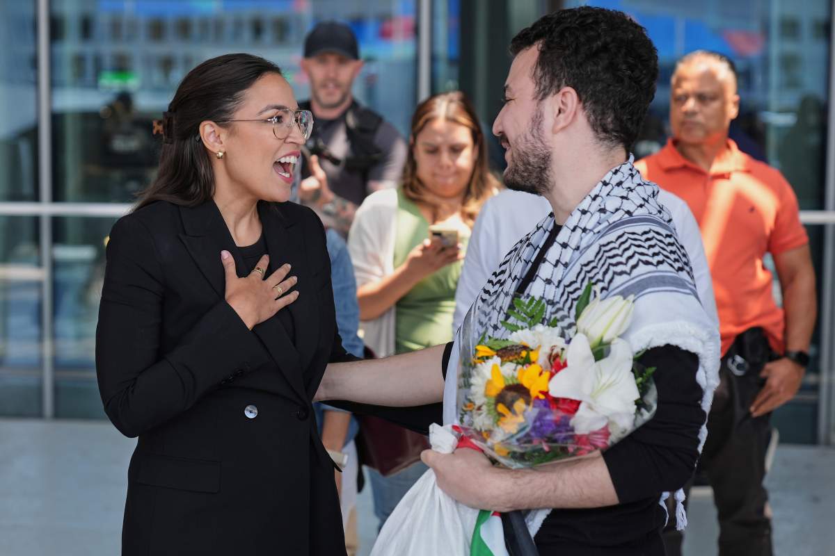 Mahmoud Khalil, right, speaks to Rep. Alexandria Ocasio-Cortez, D-N.Y., after arriving at Newark International Airport, Saturday, June 21, 2025, in Newark, N.J.