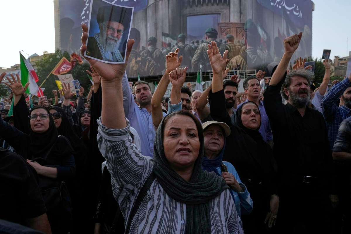 Protesters chant slogans as one of them holds up a poster of the Iranian Supreme Leader Ayatollah Ali Khamenei in a protest following the U.S. attacks on nuclear sites in Iran, in Tehran, Iran, Sunday, June 22, 2025.