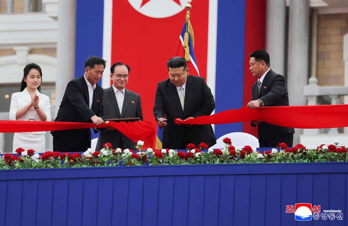 In this photo provided by the North Korean government, North Korean leader Kim Jong Un, second right, with his daughter, left, cuts the inaugural tape during a completion ceremony of the Wonsan-Kalma coastal tourist zone in North Korea, Tuesday, June 24, 2025.