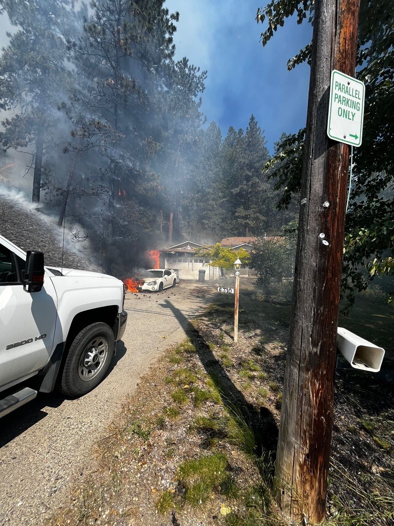 Thursday's fire next to Mill Creek damaged a home and destroyed a vehicle. 