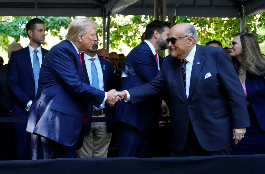President Donald Trump shakes hands with former New York City Mayor Rudy Giuliani  during a remembrance ceremony on the 23rd anniversary of the September 11 terror attack on the World Trade Center at Ground Zero, in New York City on September 11, 2024.  