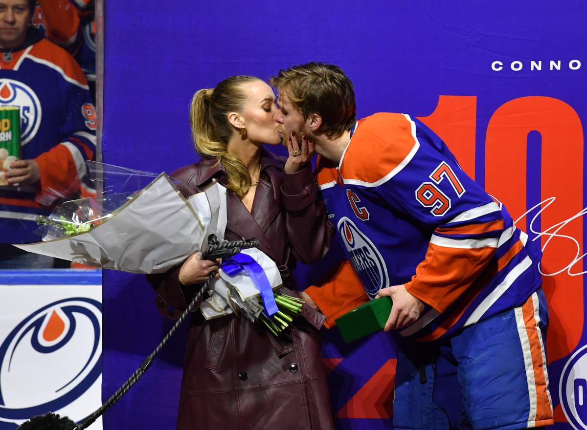 Edmonton Oilers captain Connor McDavid kisses his wife Lauren Kyle during his 1000th point ceremony prior to the game against the Columbus Blue Jackets at Rogers Place on December 5, 2024, in Edmonton.