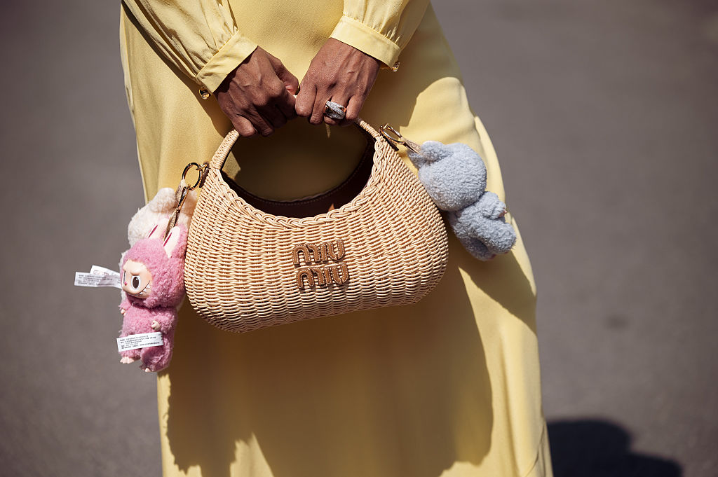 Zufi Alexander wears an all Miu Miu look made of butter yellow long summer dress and straw Miu Miu bag with attached Labubu bag charms during day five of the 78th Cannes Film Festival on May 17, 2025 in Cannes, France.