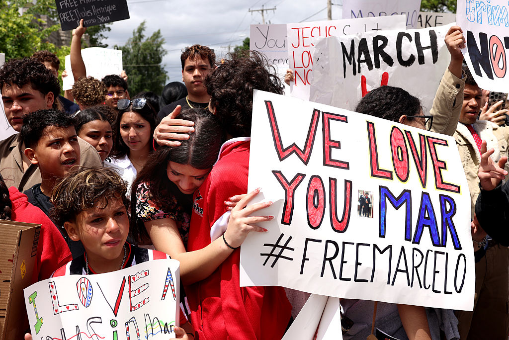 Family and classmates of Marcelo Gomes Da Silva embrace as they protest outside of Milford Town Hall on June 1, 2025, a day after 18-year-old Marcelo Gomes Da Silva was detained by ICE on his way to volleyball practice.