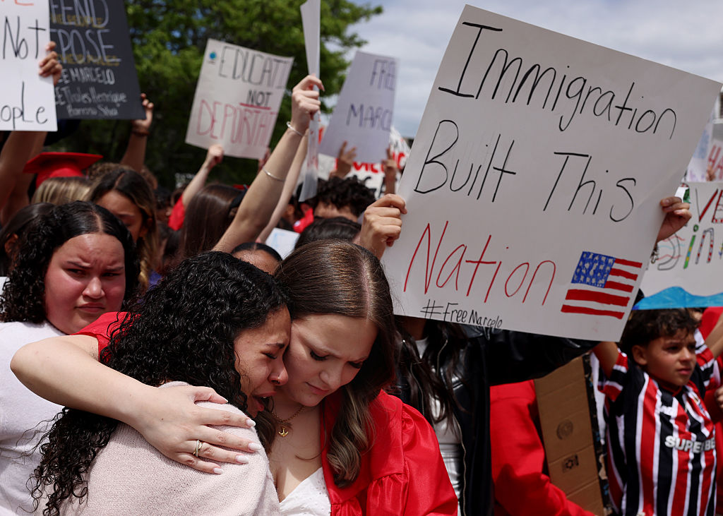Family and classmates of Marcelo Gomes Da Silva embrace as they protest outside of Milford Town Hall on June 1, 2025, a day after Da Silva was detained by ICE on his way to volleyball practice.