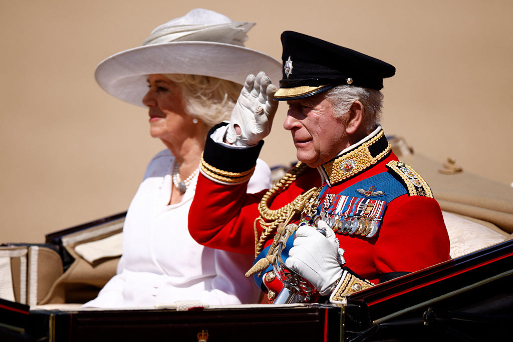 Britain's King Charles III salutes next to Britain's Queen Camilla as they arrive to Horse Guards Parade for the King's Birthday Parade, "Trooping the Colour", in London on June 14, 2025.