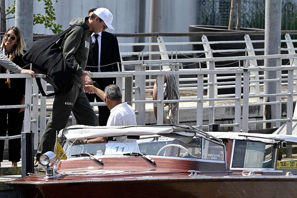 Tom Brady prepares to board a taxi boat after landing at Venice Marco Polo airport ahead of Jeff Bezos' wedding on June 26, 2025.