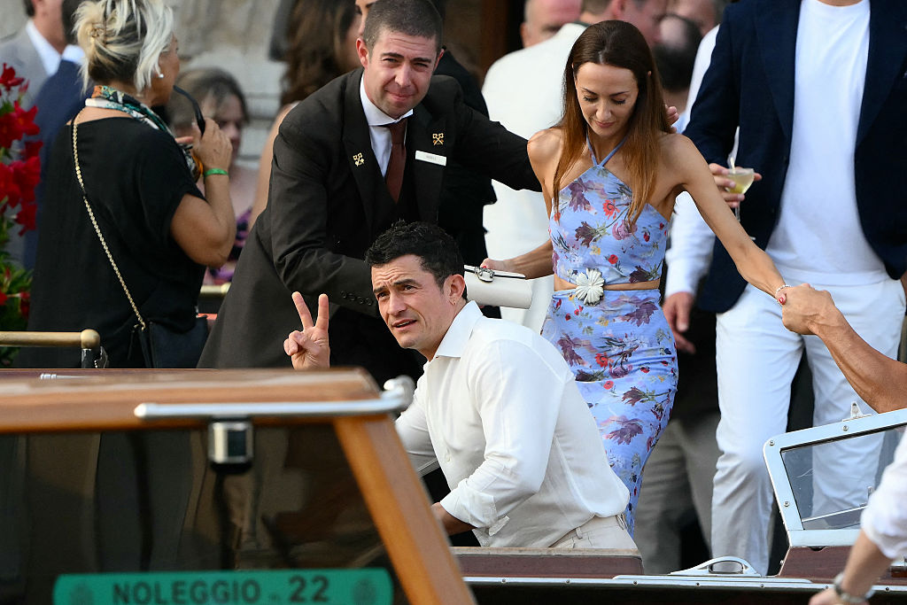 Orlando Bloom climbs into a taxi boat at the Gritti Palace Hotel ahead of the wedding of Amazon's founder Jeff Bezos with Lauren Sanchez in Venice on June 26, 2025.